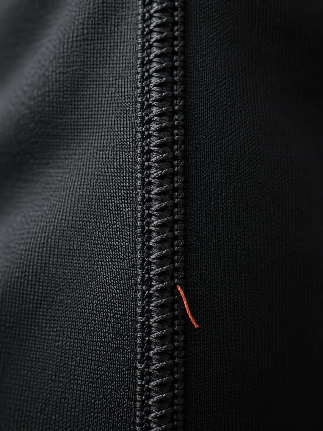 Close-up of a flatlock seam on black activewear fabric